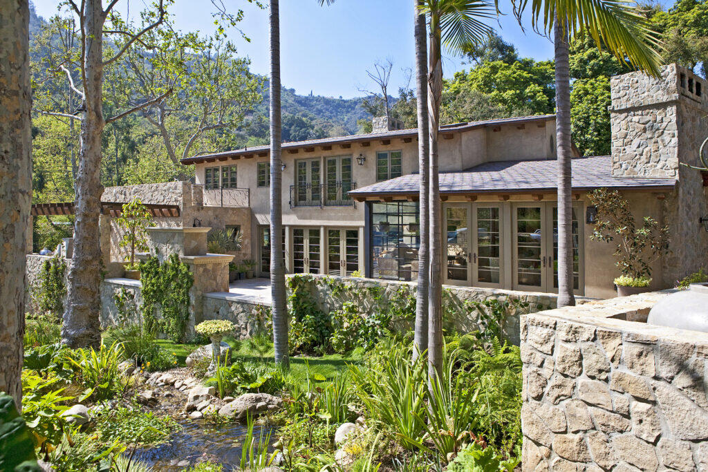 StoneCanyon01 Custom Residence in Bel Air California featuring natural stone veneer with a landscaped spring by Hayne Architects.