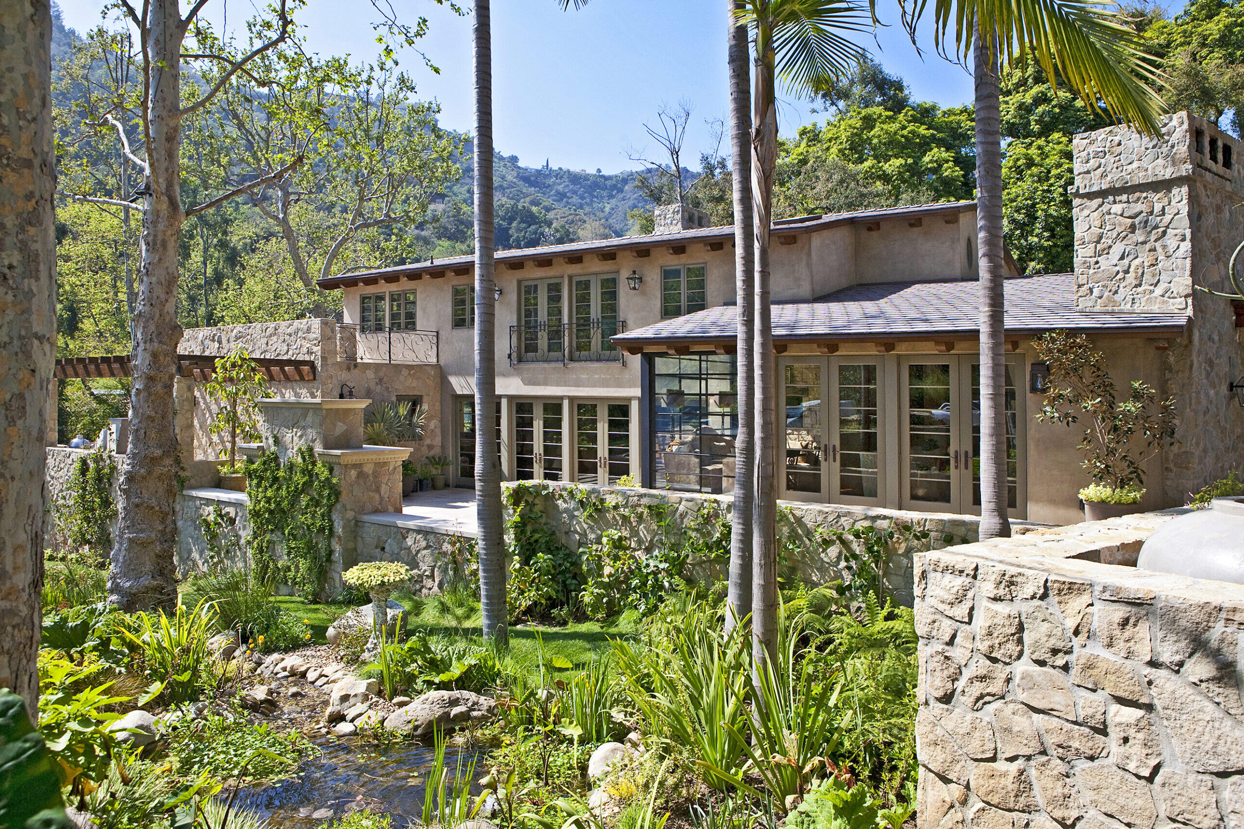 Custom Residence in Bel Air California featuring natural stone veneer with a landscaped spring by Hayne Architects.