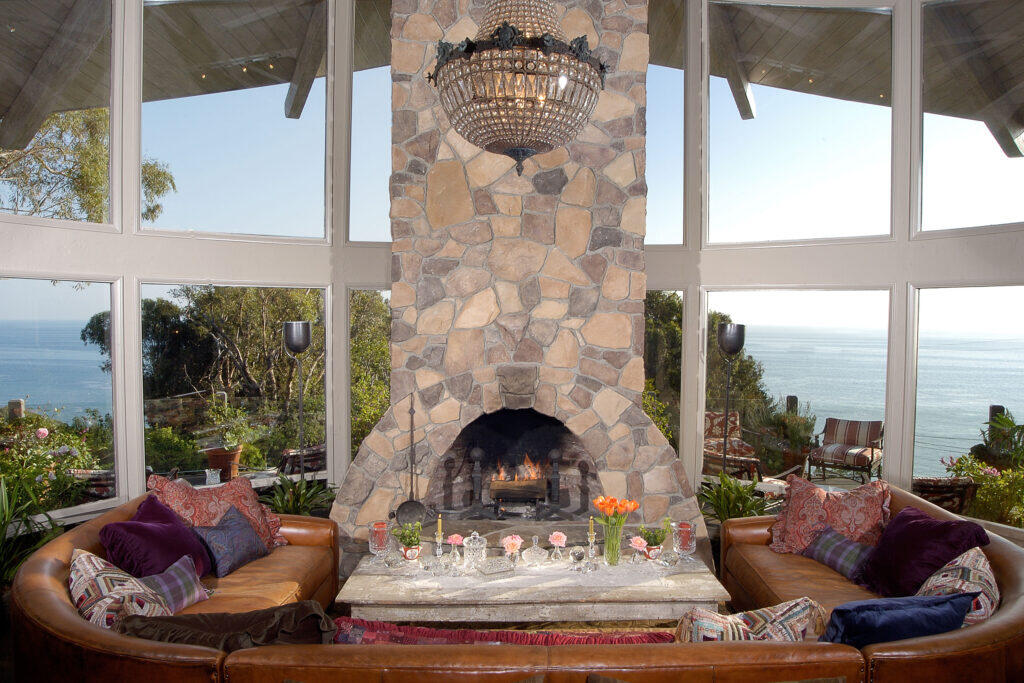 FlyingNun03 Interioor Living Room with natural stone fireplace an ocean view.