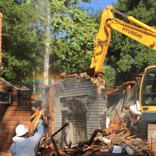 Demolition of a house to prepare for new construction. Rainbow.