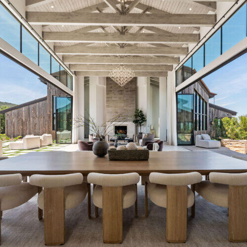 Vaulted Great Room with exposed trellises and glass walls.