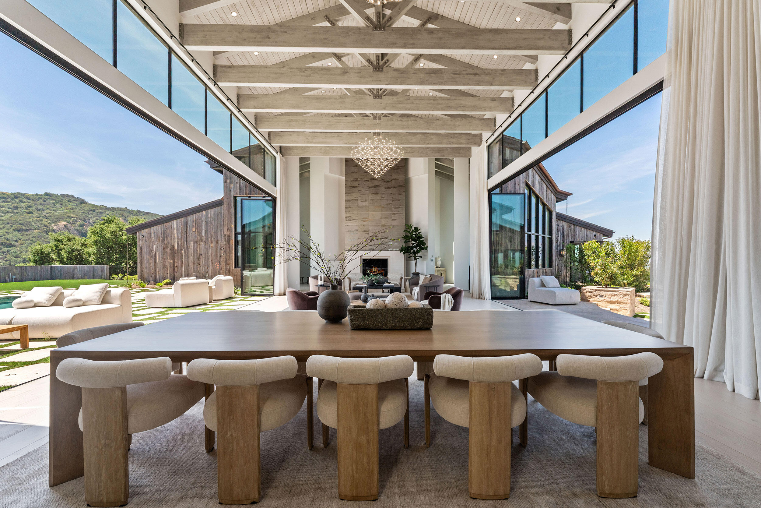 Vaulted Great Room with exposed trellises and glass walls.