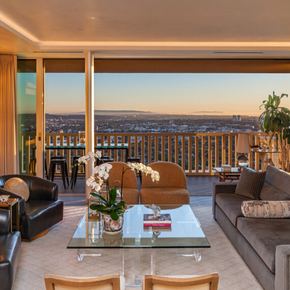 Living Room in West Hollywood apartment by Hayne Architects featuring venetian plaster ceiling, large format tile and full-height sliding glass doors.
