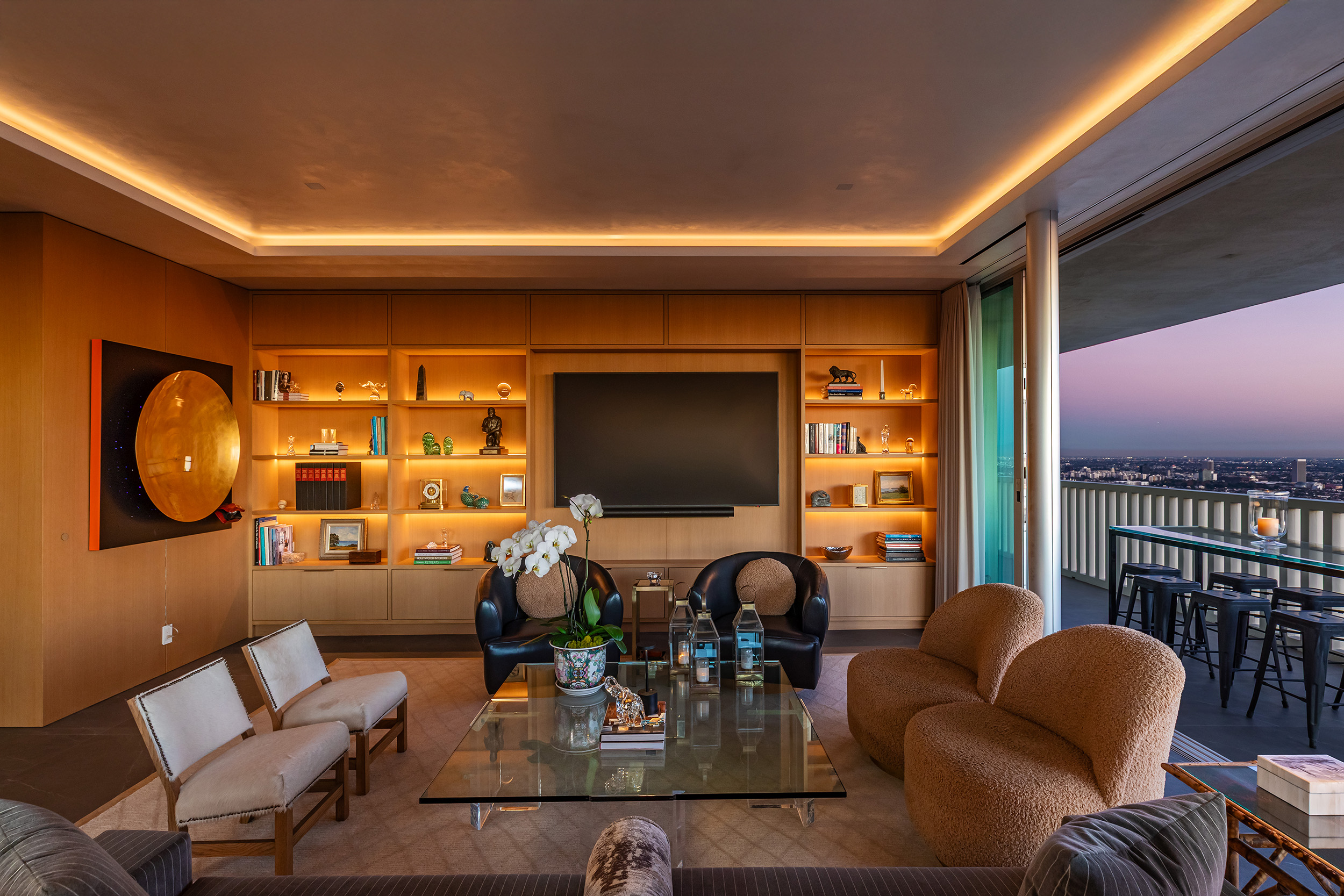 Living Room in West Hollywood apartment by Hayne Architects featuring venetian plaster ceiling, white oak cabinetry, white oak wall paneling and full-height sliding glass doors.