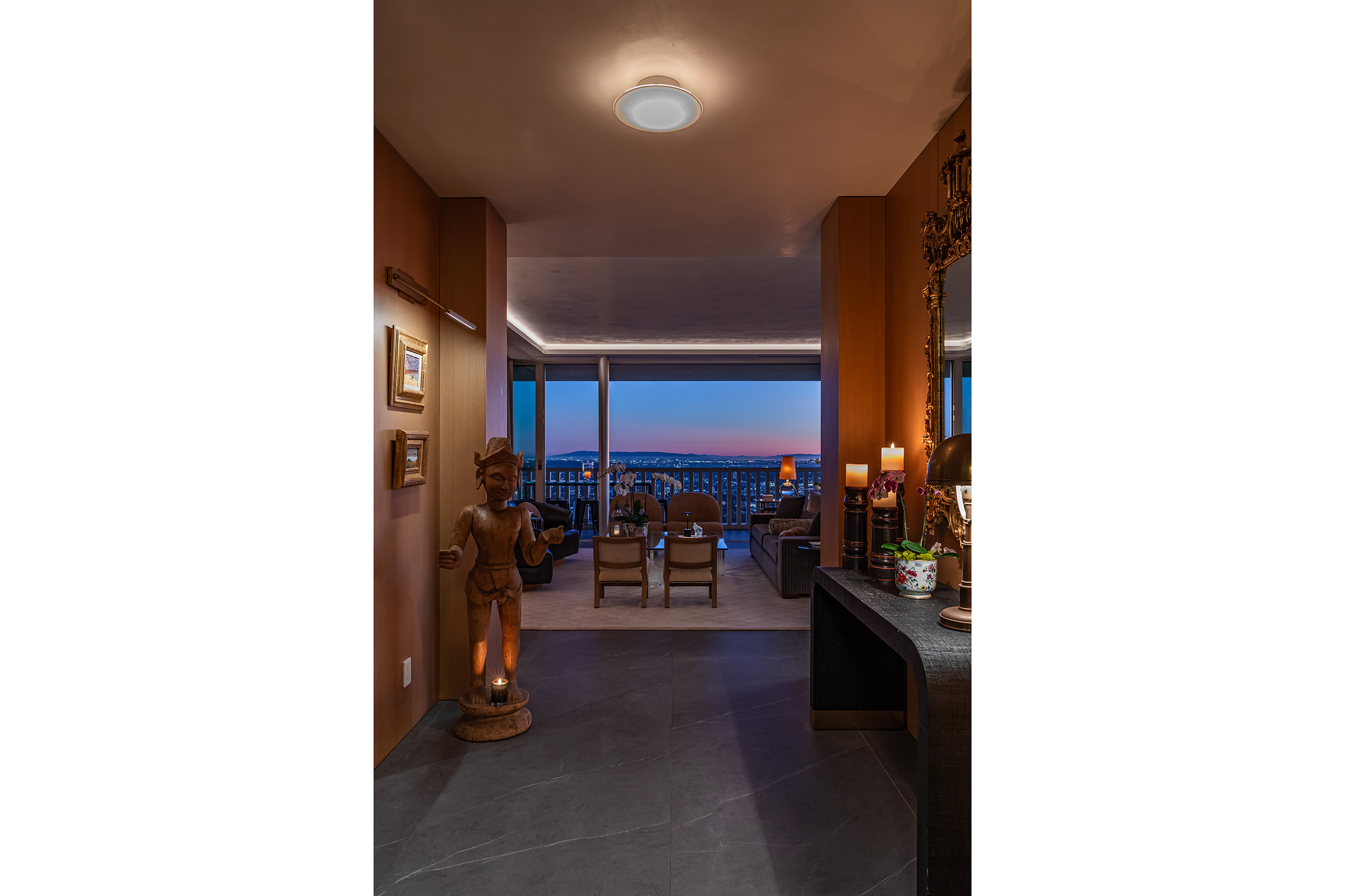 Entry Hall in West Hollywood apartment by Hayne Architects featuring venetian plaster ceiling, large format tile and full-height sliding glass doors.