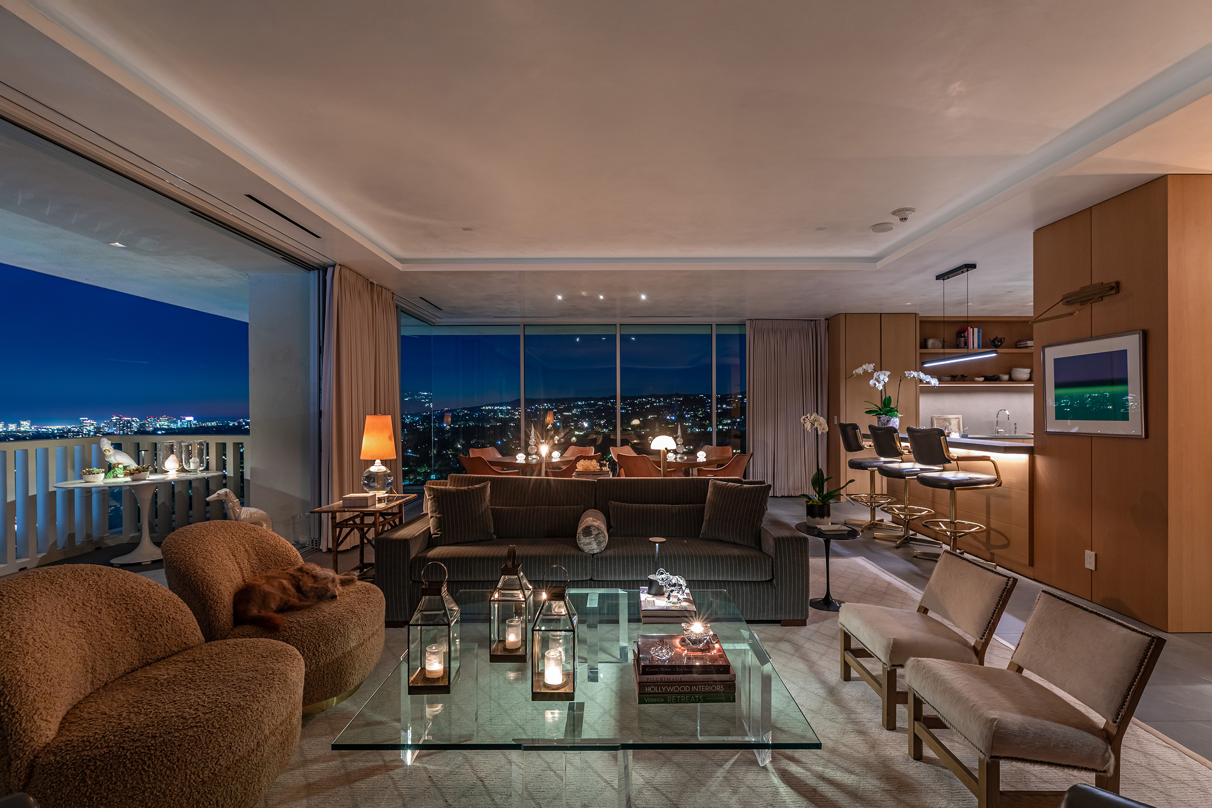 Living Room in West Hollywood apartment by Hayne Architects featuring venetian plaster ceiling, large format tile and full-height sliding glass doors.
