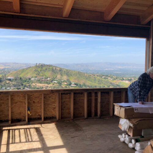 Robbin Hayne reviewing plans at the Ridgehouse under-construction.