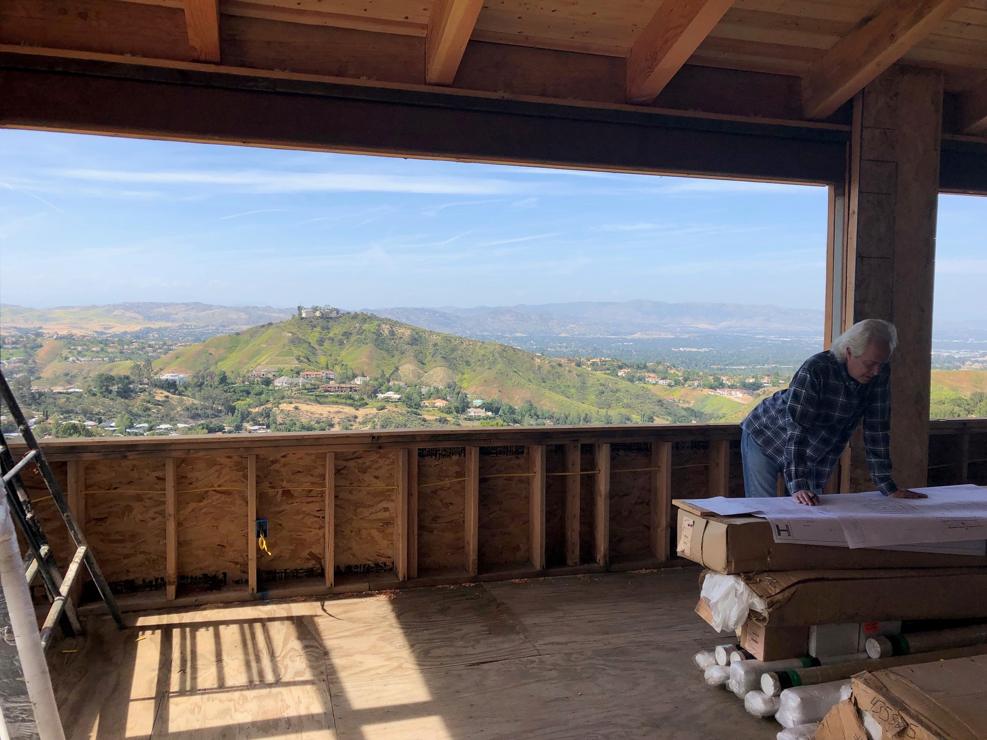 Robbin Hayne reviewing plans at the Ridgehouse under-construction.