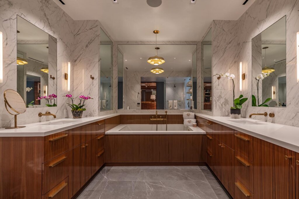 Modern bathroom in West Hollywood residence designed by Hayne Architects with walnut cabinetry, marble countertops, and built-in soaking tub.