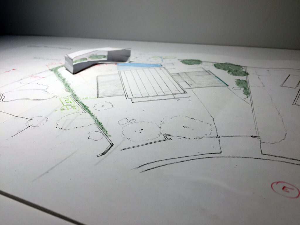 Photograph of folded paper model for the Monocoque Pool House.